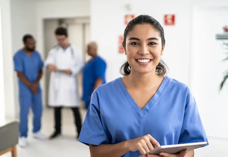 Portrait of female nurse using tablet at hospital